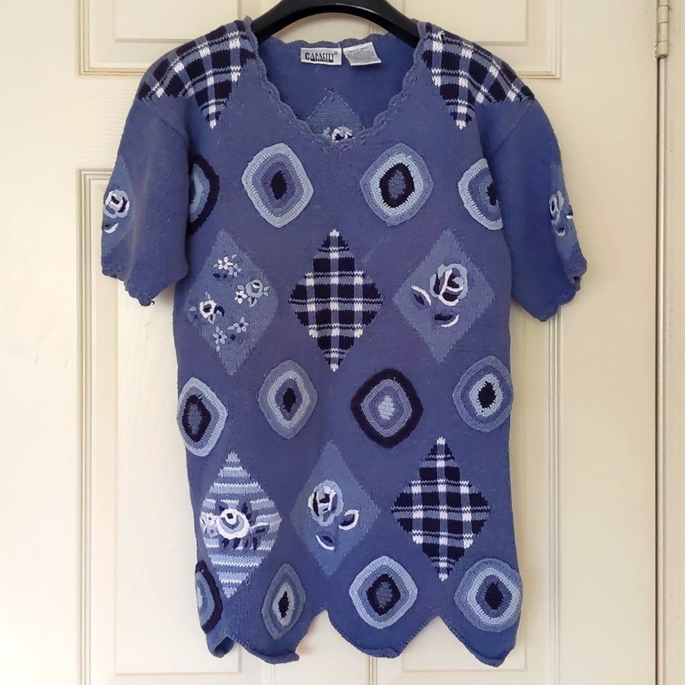 Women short sleeve knit sweater with embroidery and design.